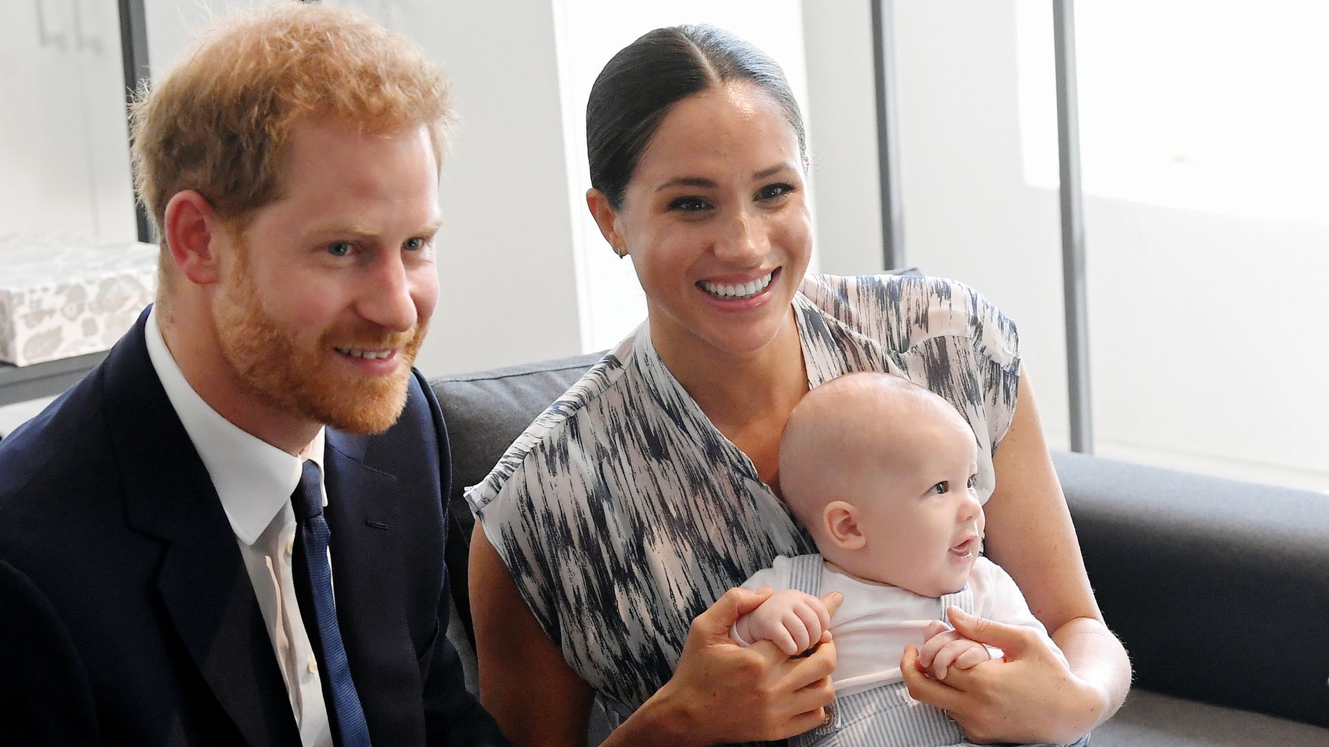 Harry and Meghan smiling with baby Archie in South Africa
