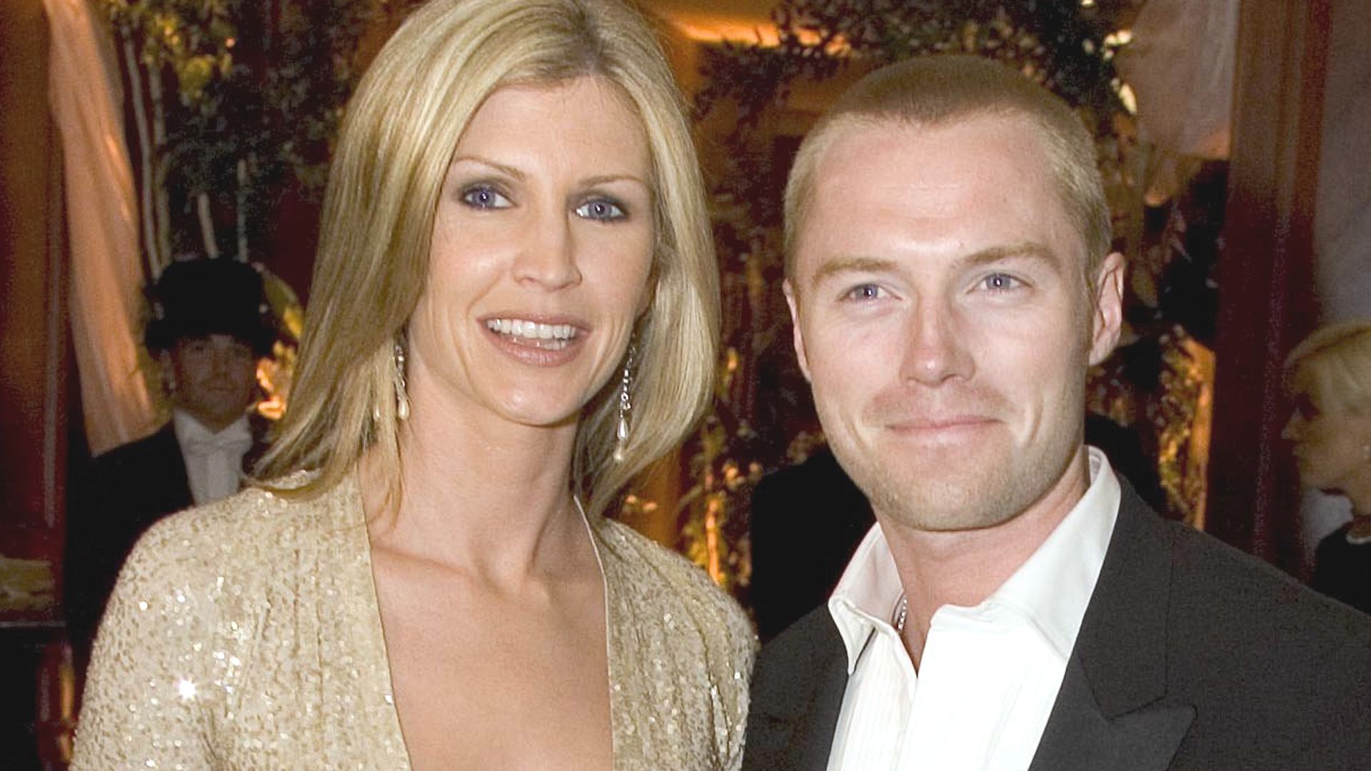 Yvonne in a gold dress and Ronan Keating in a black suit