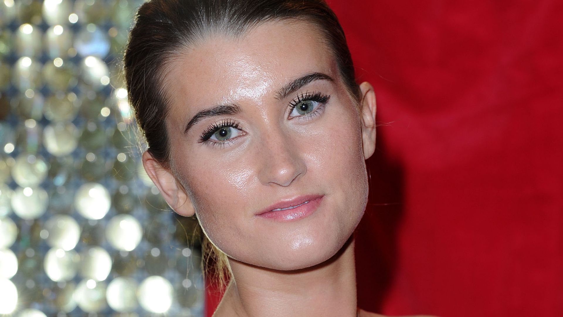 Charley Webb wows in plunging black swimsuit for family day out