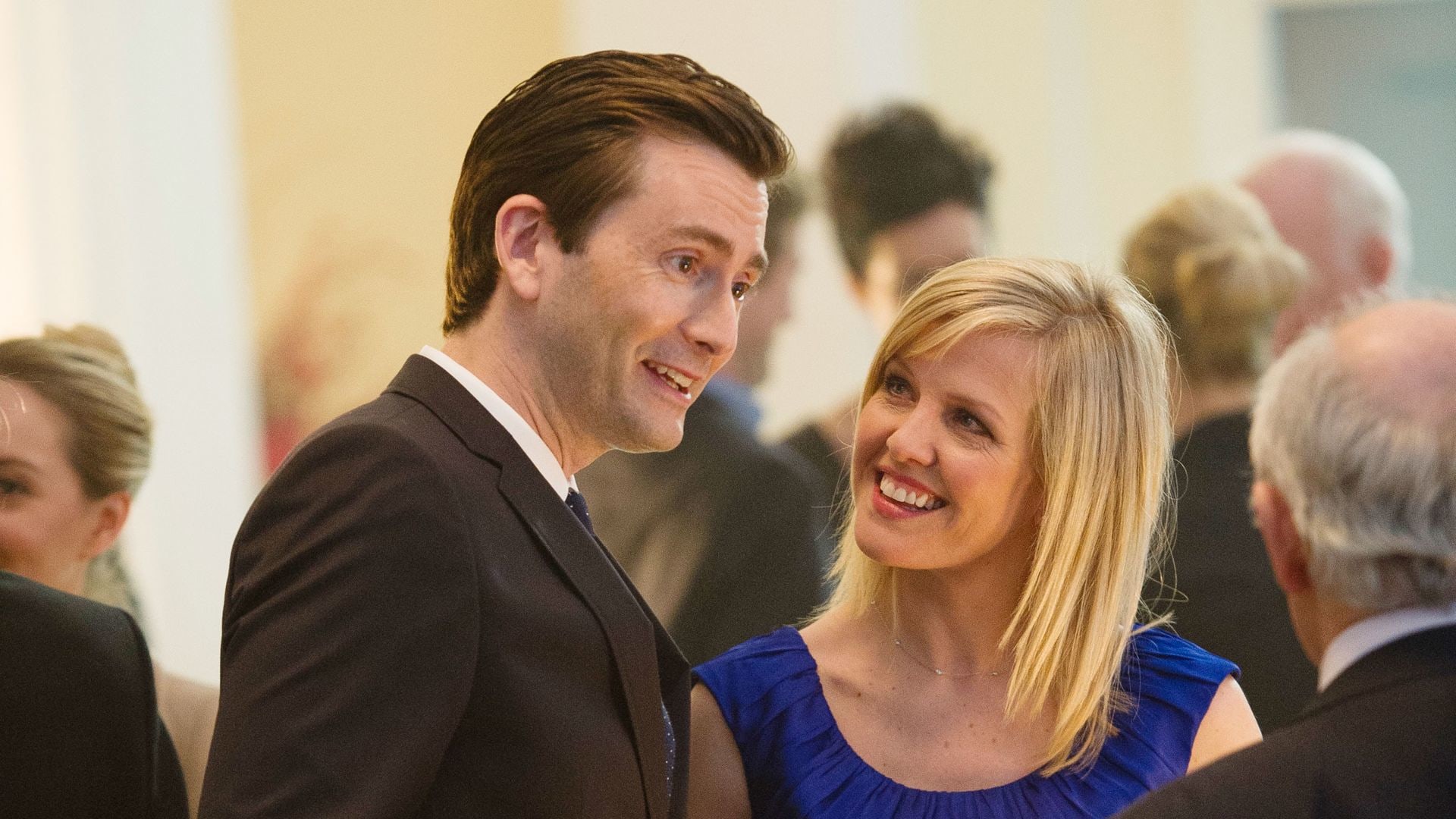 man and woman talking at party