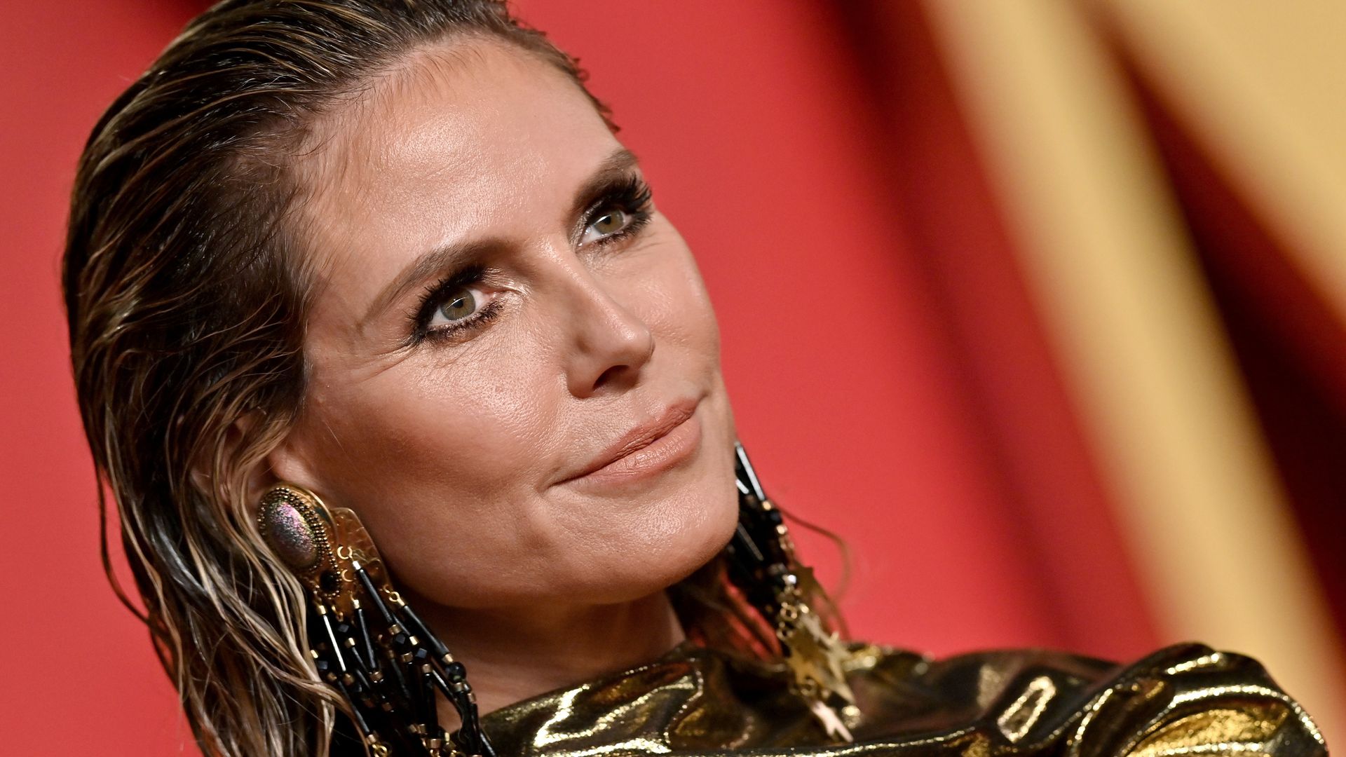 Heidi Klum, 50, is a mermaid goddess in super cinched dress with 70s