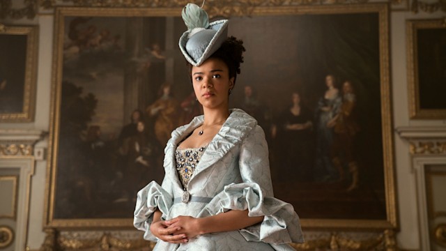 India Amarteifio stands in front of portrait as Young Queen in Queen Charlotte