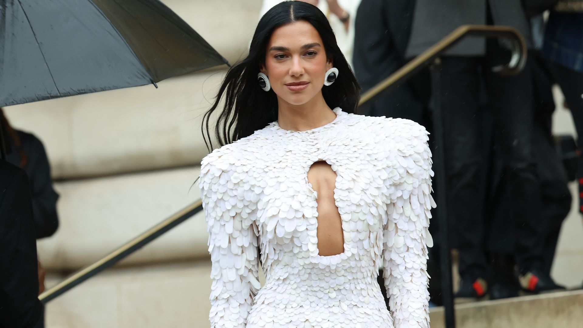Dua Lipa attends the Schiaparelli Haute Couture Fall/Winter 2025/2026 show as part of Paris Fashion Week in white cut-out dress