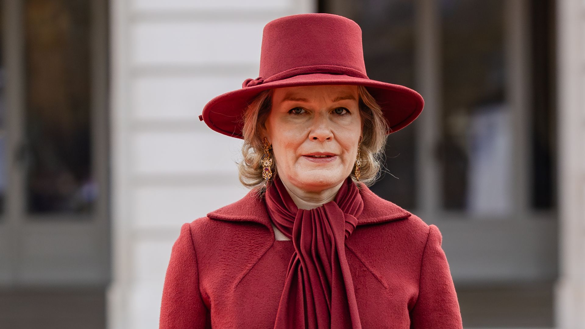 Queen Mathilde stuns in red hot coat and killer heels