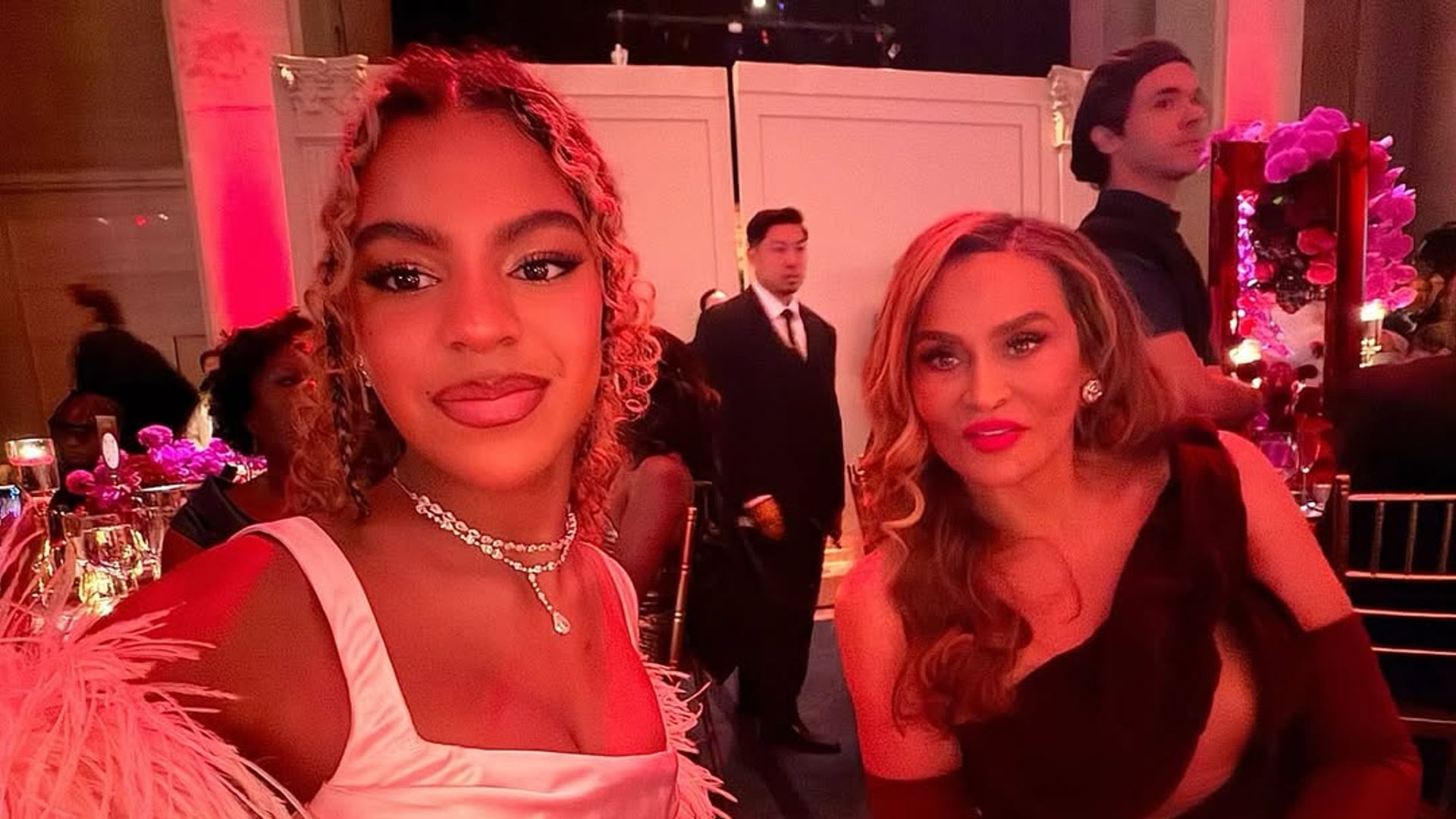 Blue Ivy in pink dress and Tina Knowles in burgundy dress