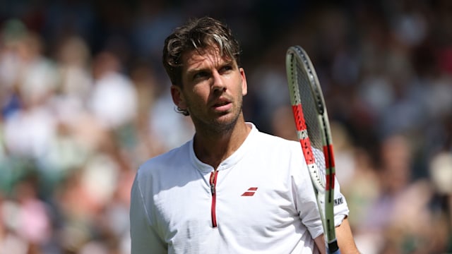 Cameron Norrie at Wimbledon holding a tennis racket