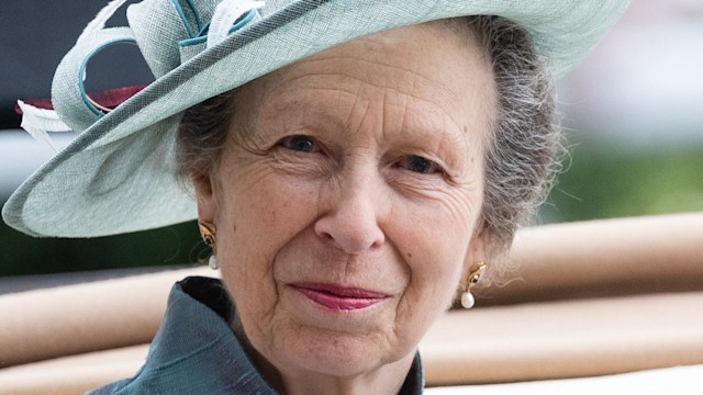 Princess Anne in blue outfit and hat in carriage close up