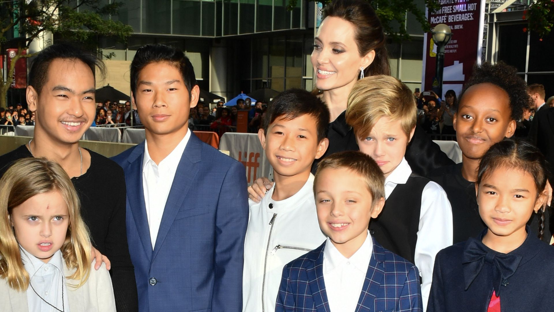 Angelina Jolie surrounded by her children and two child stars at a red carpet film premiere