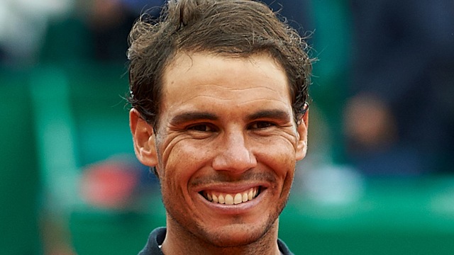 man holding trophy at tennis tournament 