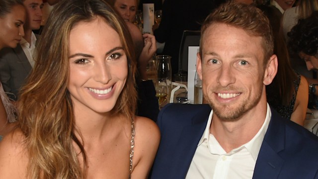 Brittny Ward in a black dress with Jenson Button in a blue suit at a dinner table
