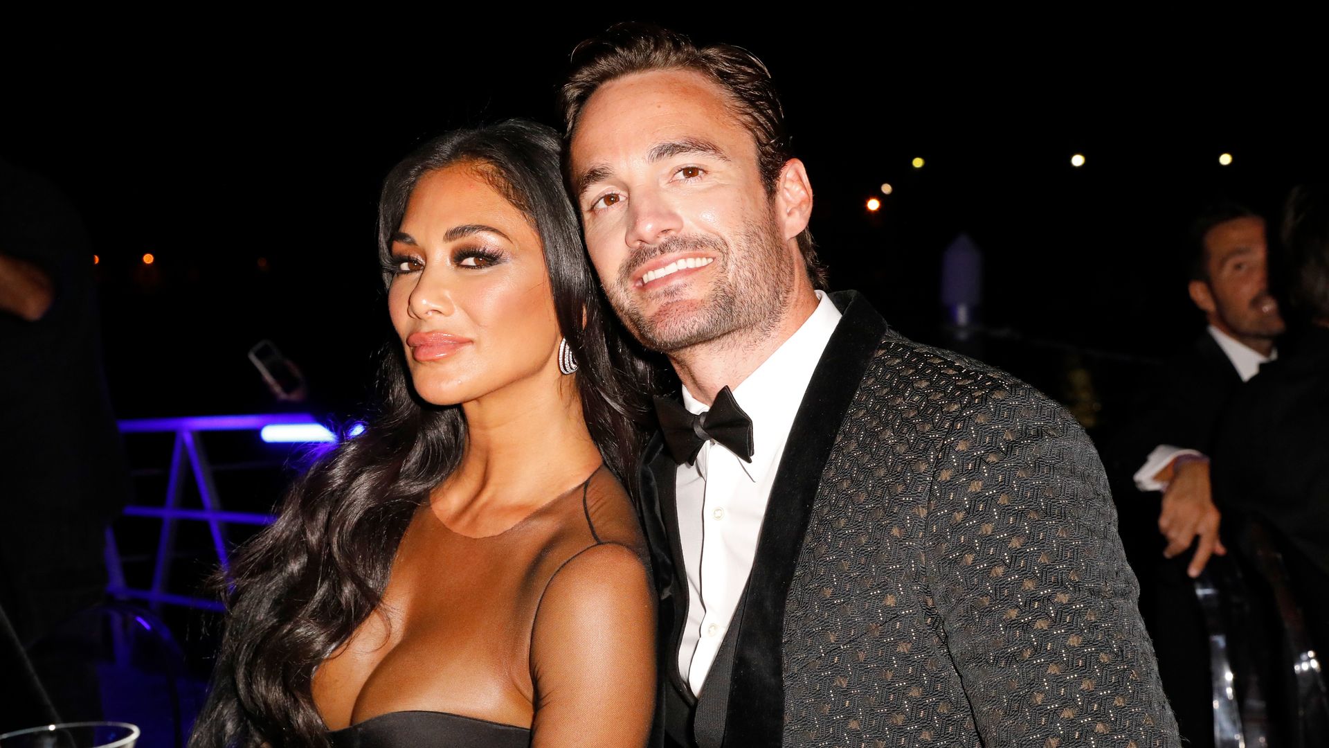 Nicole Scherzinger and Thom Evans hug black tie event smile