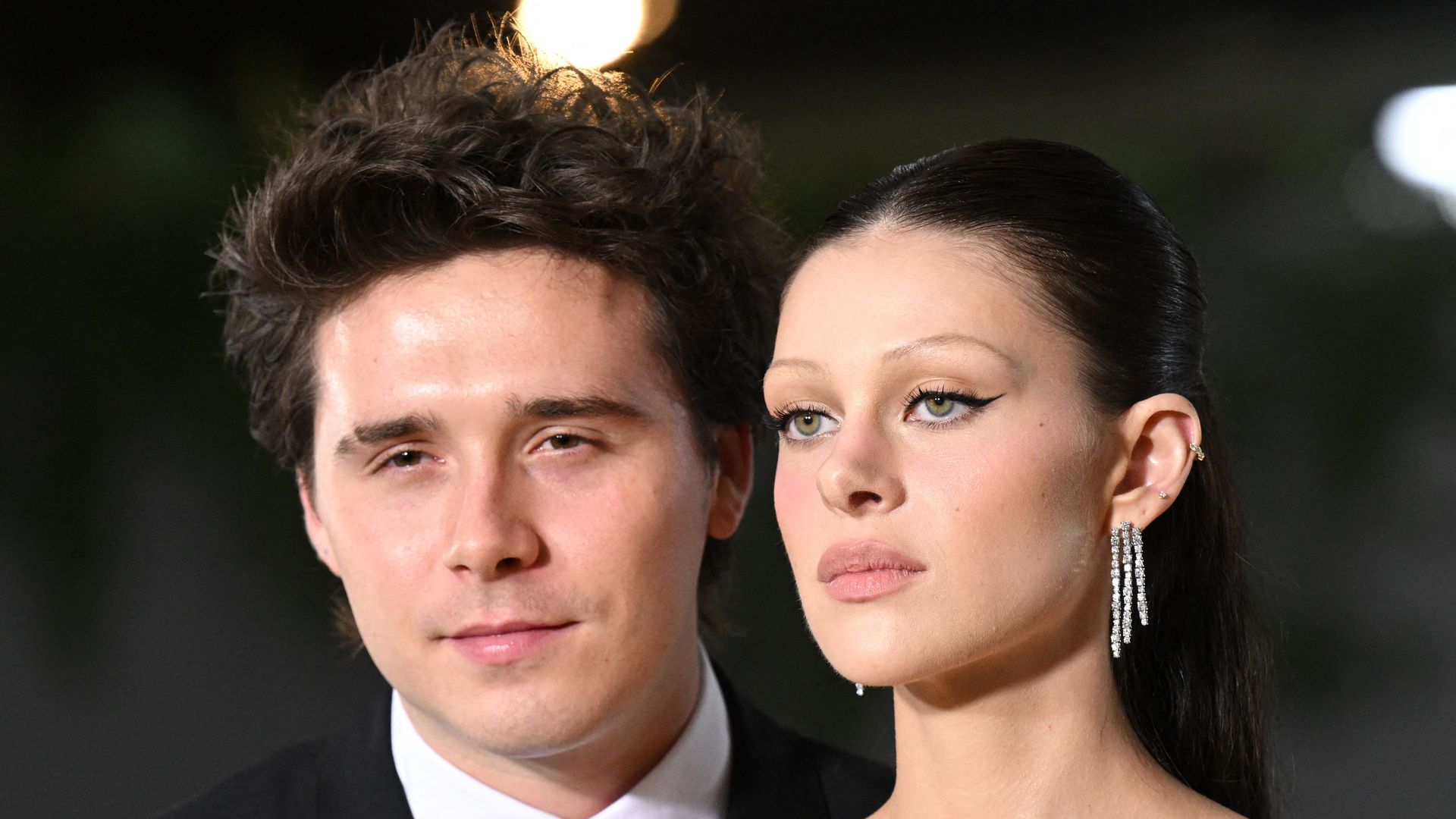 brooklyn beckam and nicola peltz posing at gala in black outfits