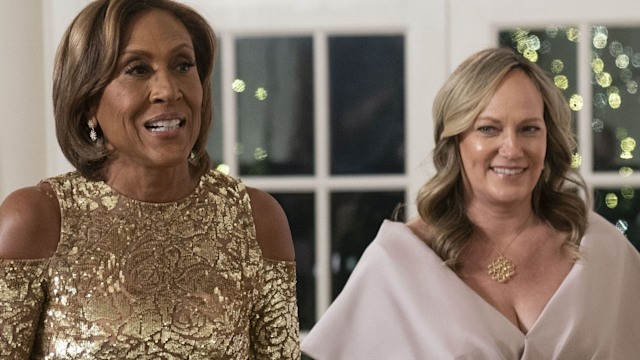 Robin Roberts in a gold dress and Amber Laign in a pink dress