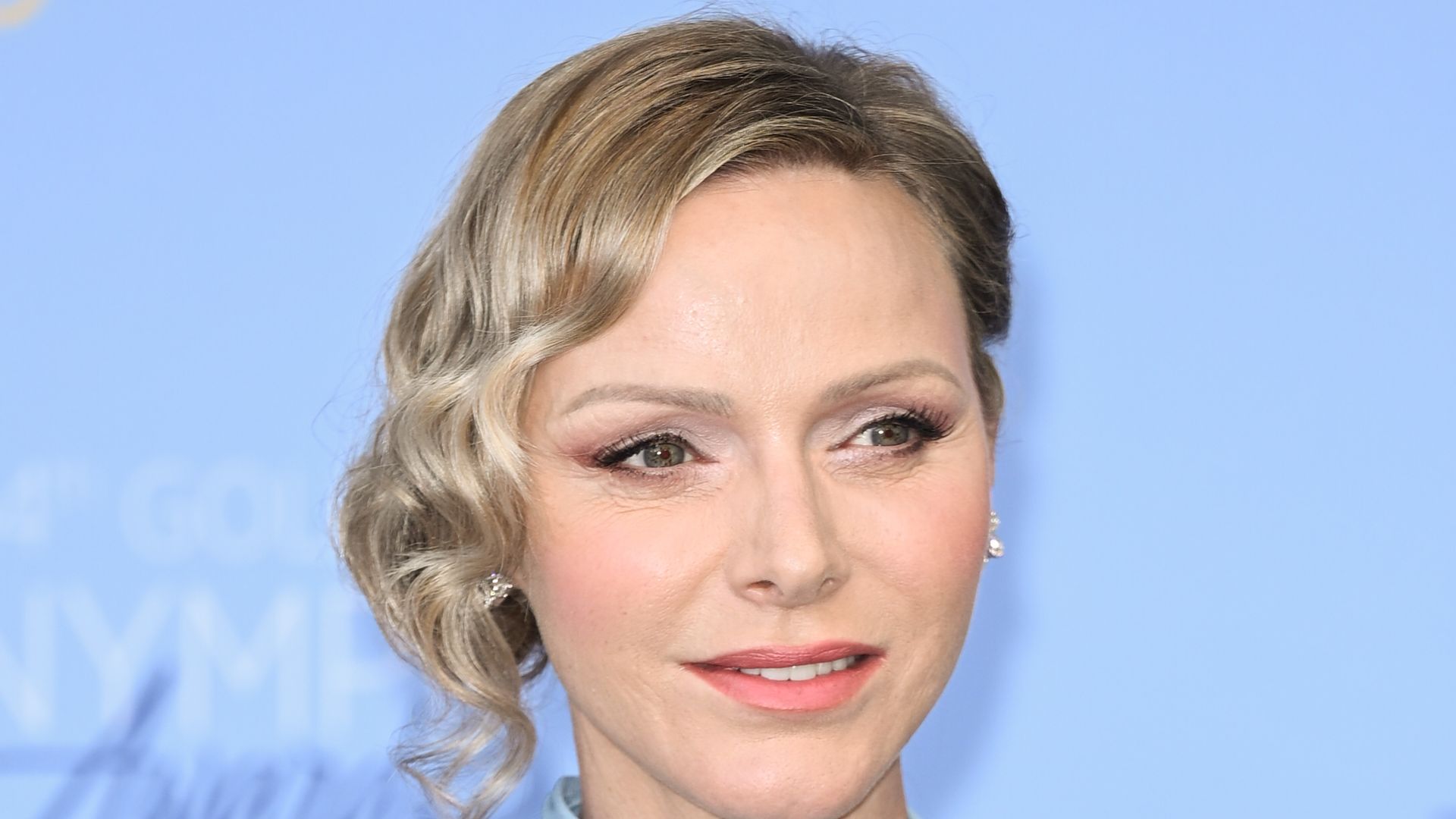 Princess Charlene shoulders up in light blue dress