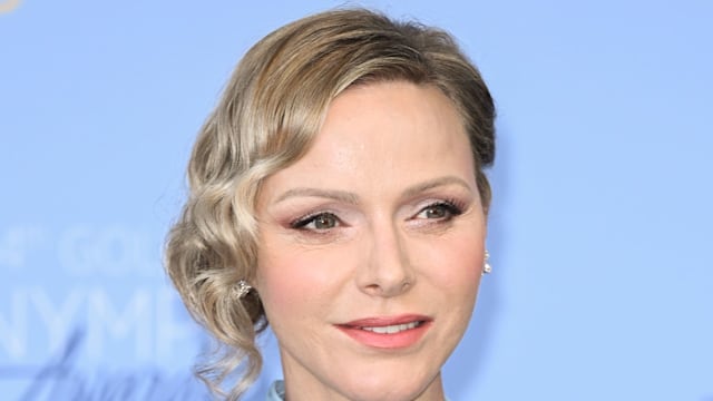 Princess Charlene shoulders up in light blue dress