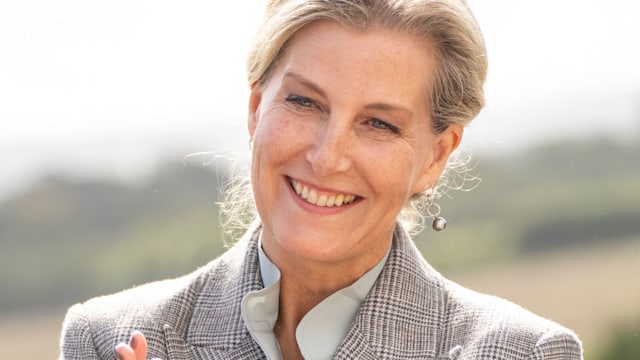 Duchess Sophie clapping in a suit with a silver ring