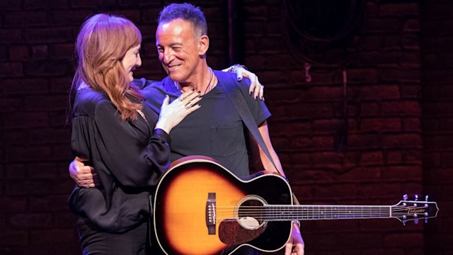 Bruce Springsteen and wife Patti Scialfa share a hug on stage. 