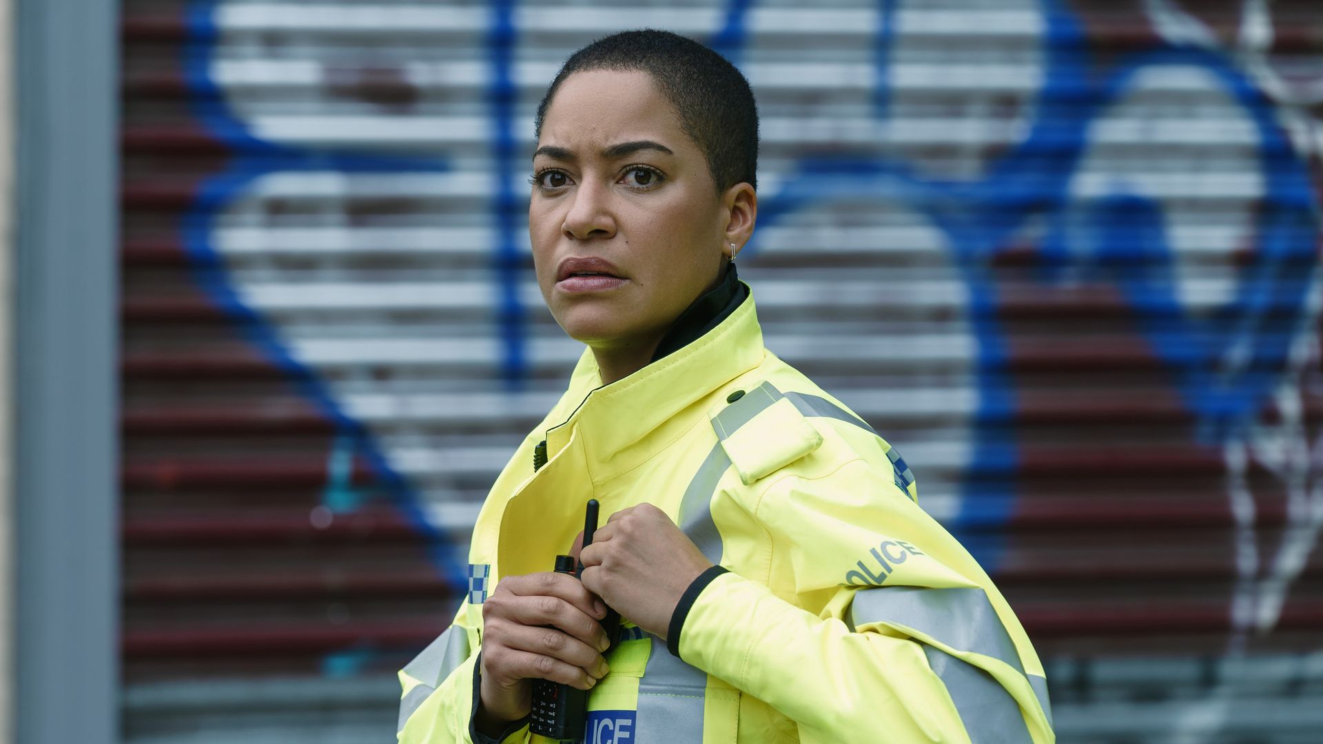 woman in police jacket in street
