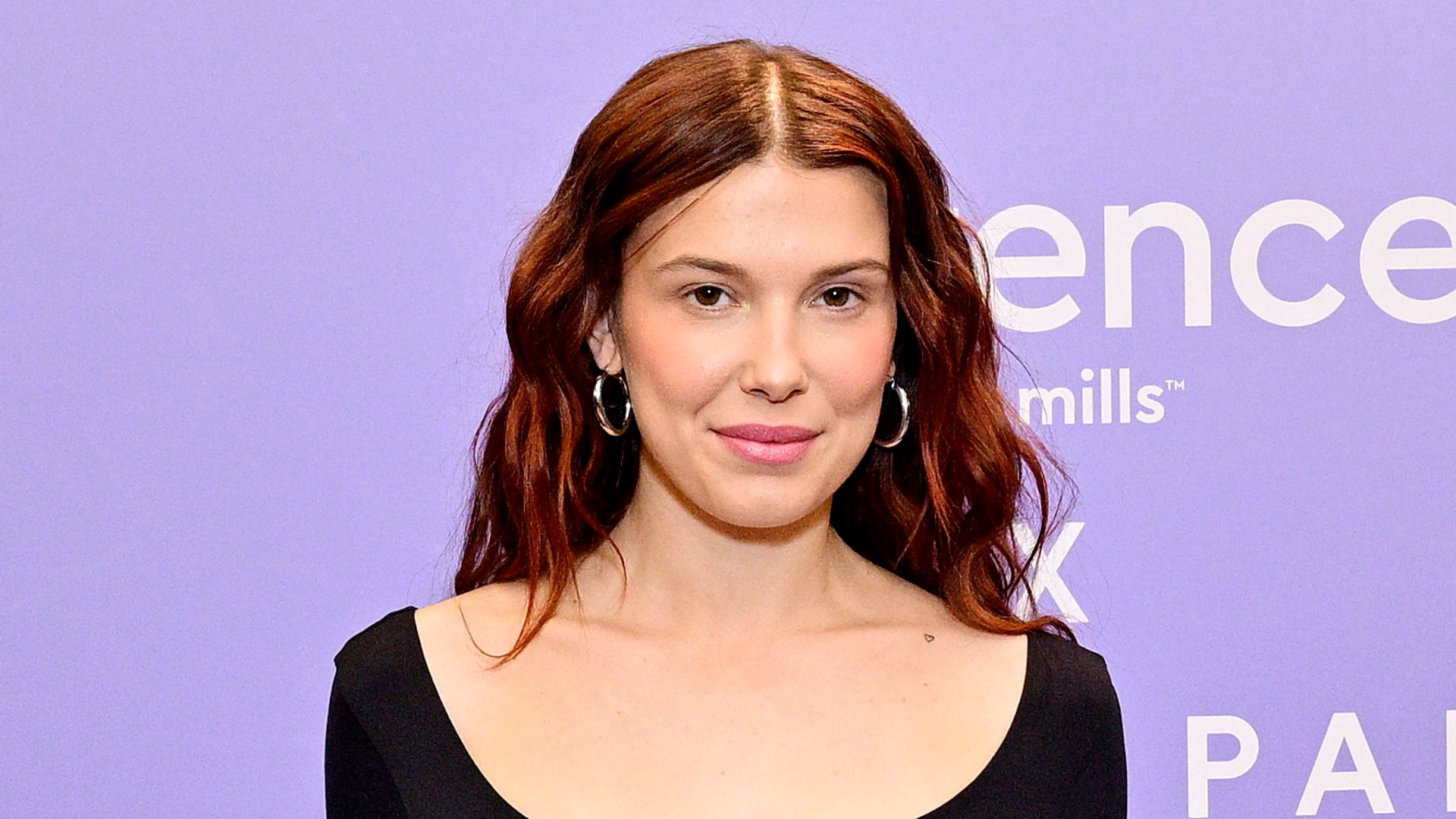 Millie Bobby Brown's scoop neck bodysuit and jeans combo is the epitome of laidback dressing