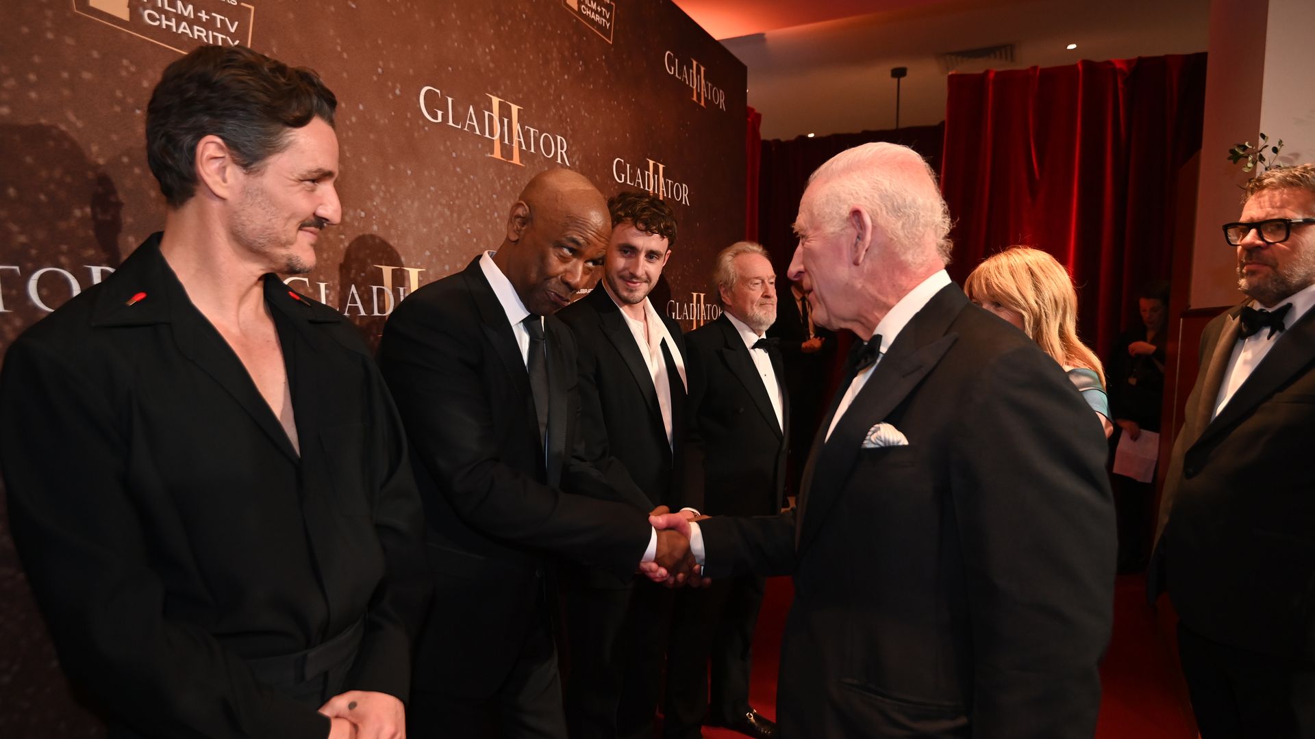 King Charles shaking hands with Denzel Washington