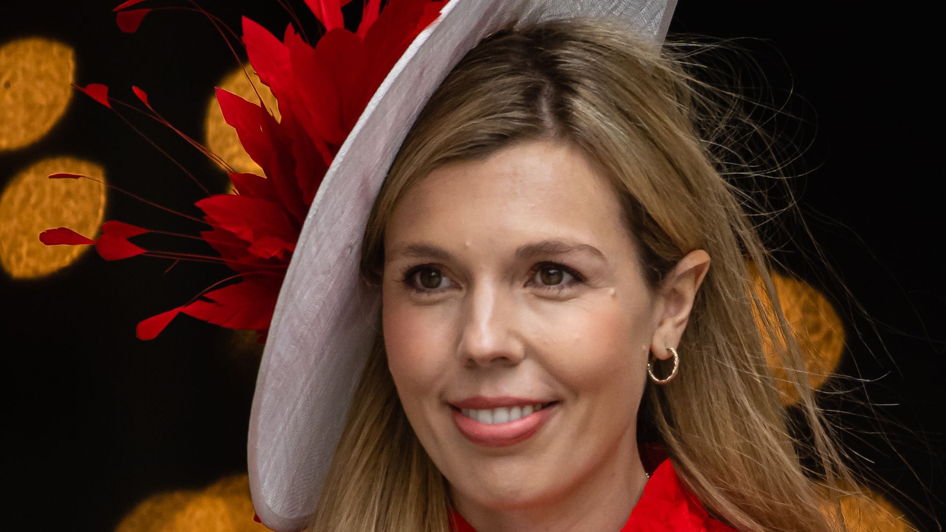 Carrie Johnson in a red outfit