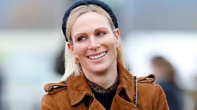 Zara Tindall wearing brown coat and blue headband