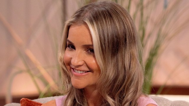 Helen Skelton sitting in a pink dress