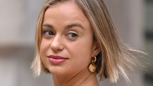 Lady Amelia Windsor looking over her shoulder in a blue off the shoulder dress