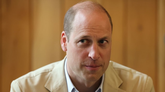 Prince William looking suspicious in a cream blazer