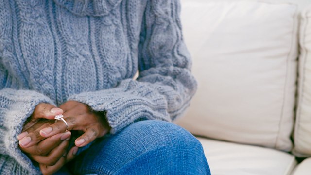 Close-up of unrecognizable black woman removing ring from finger