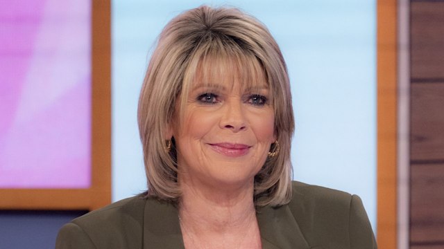 Ruth Langsford in orange shirt and green coat