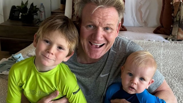 father posing for photo with two sons 