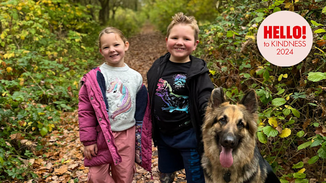 brother and sister outside with pet dog 