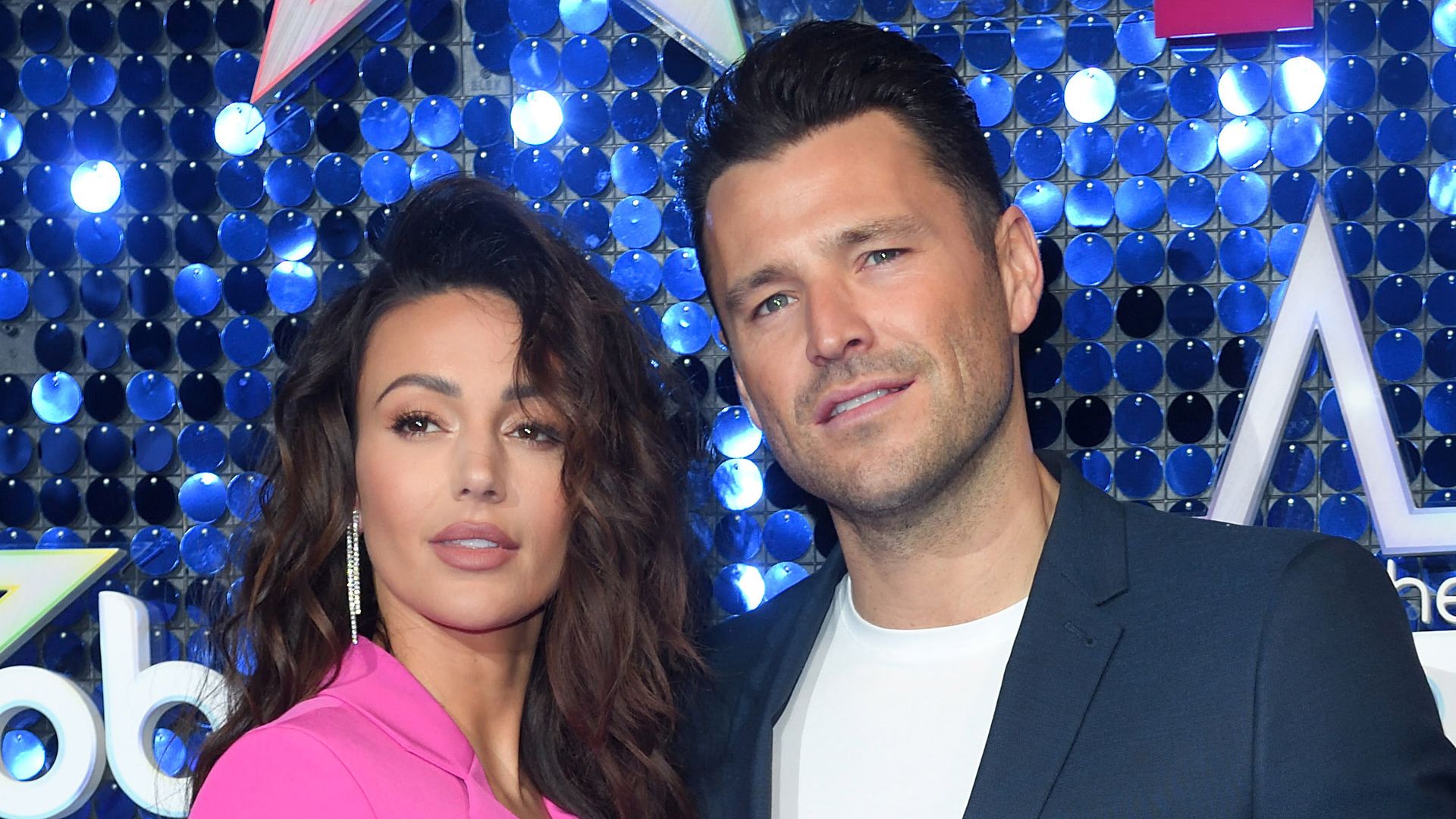 Michelle Keegan in pink suit and Mark Wright in suit