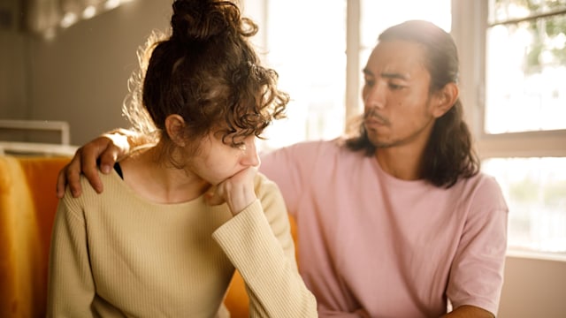 Man giving his distressed friend emotional support during difficult moments