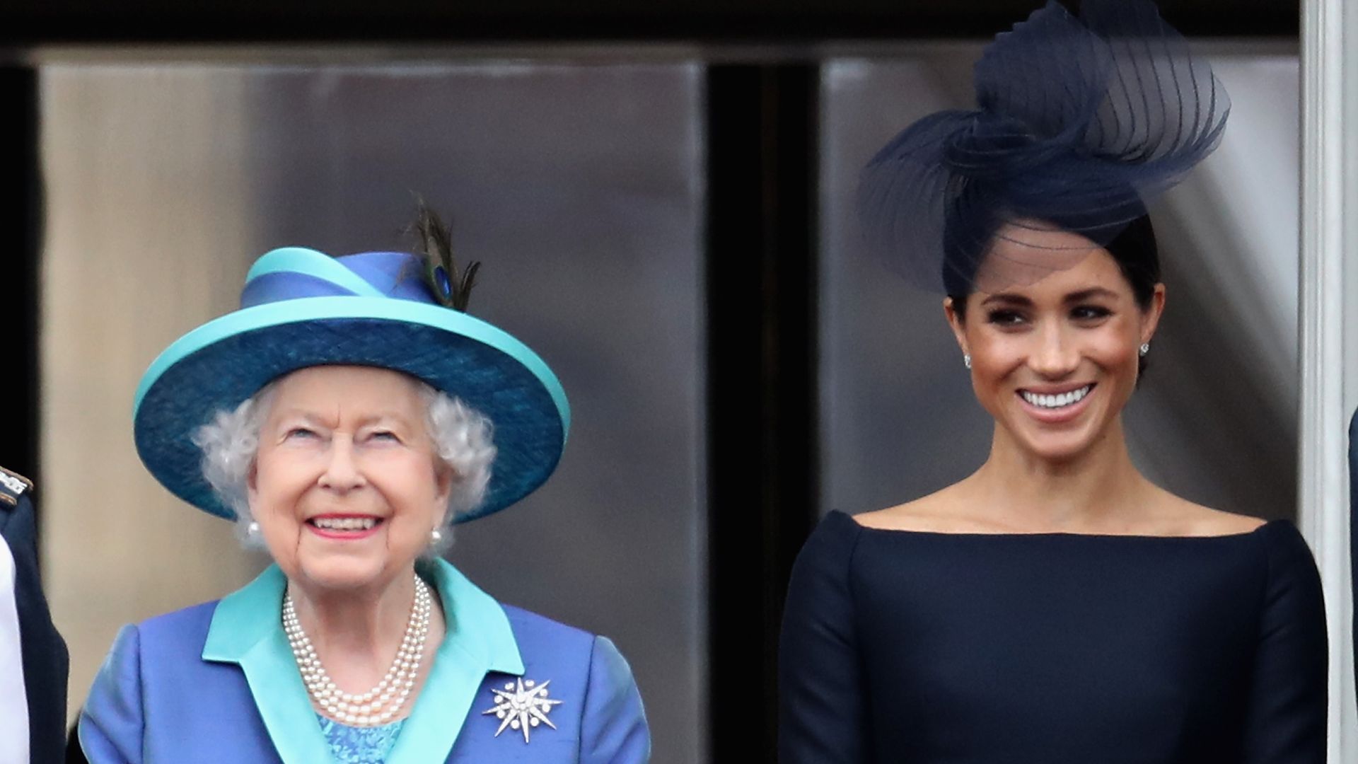 The Queen standing next to Meghan Markle