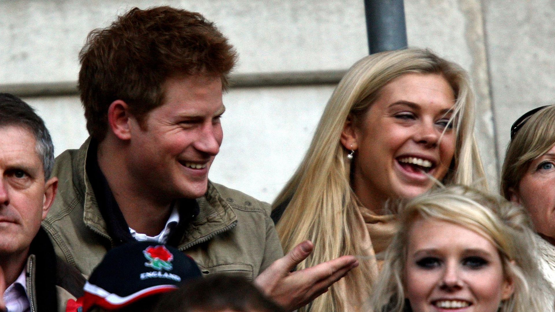 Prince Harry and Chelsy Davy sat smiling watching rugby together