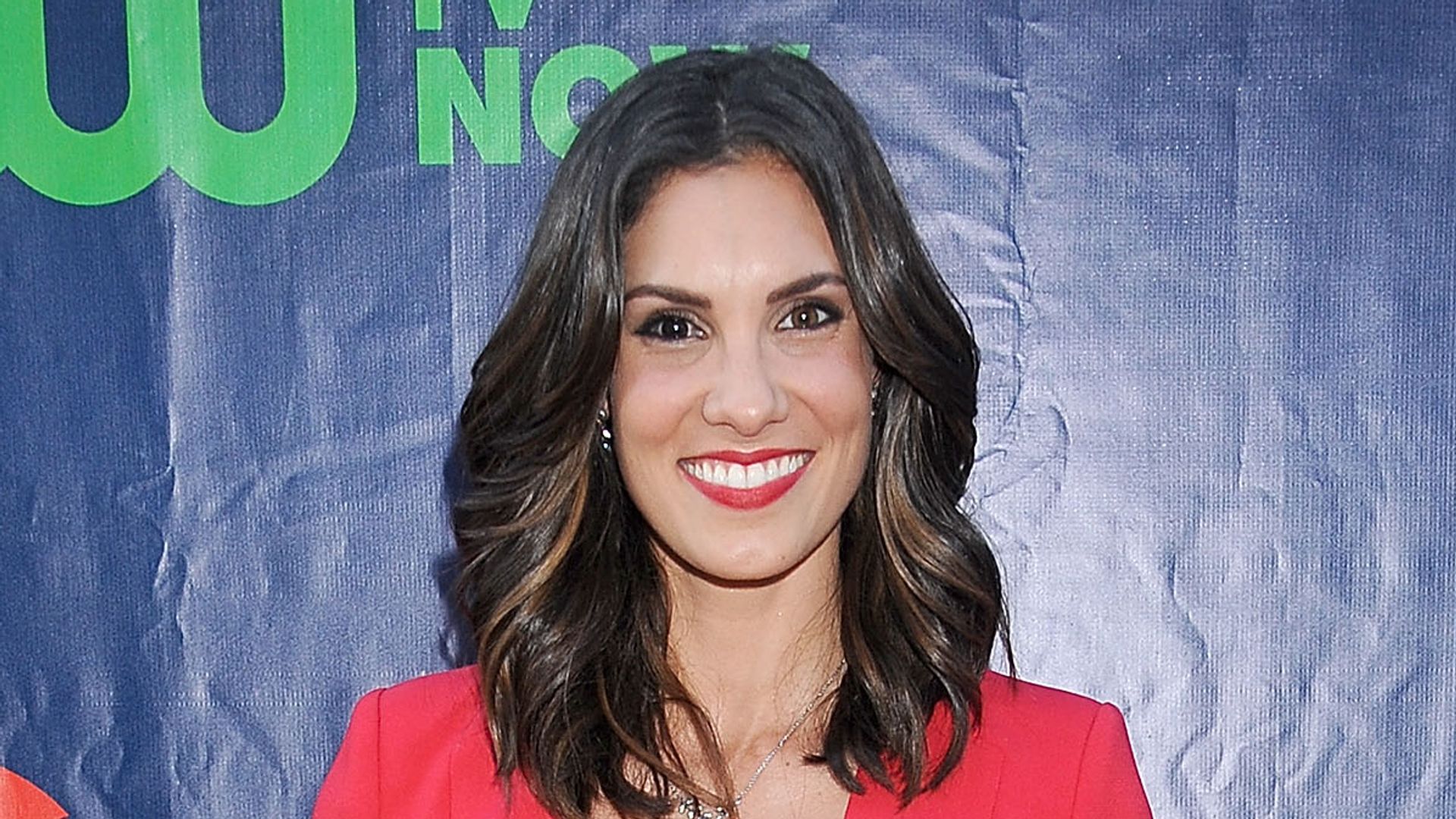 Daniela Ruah wears red blazer at The CW event red carpet