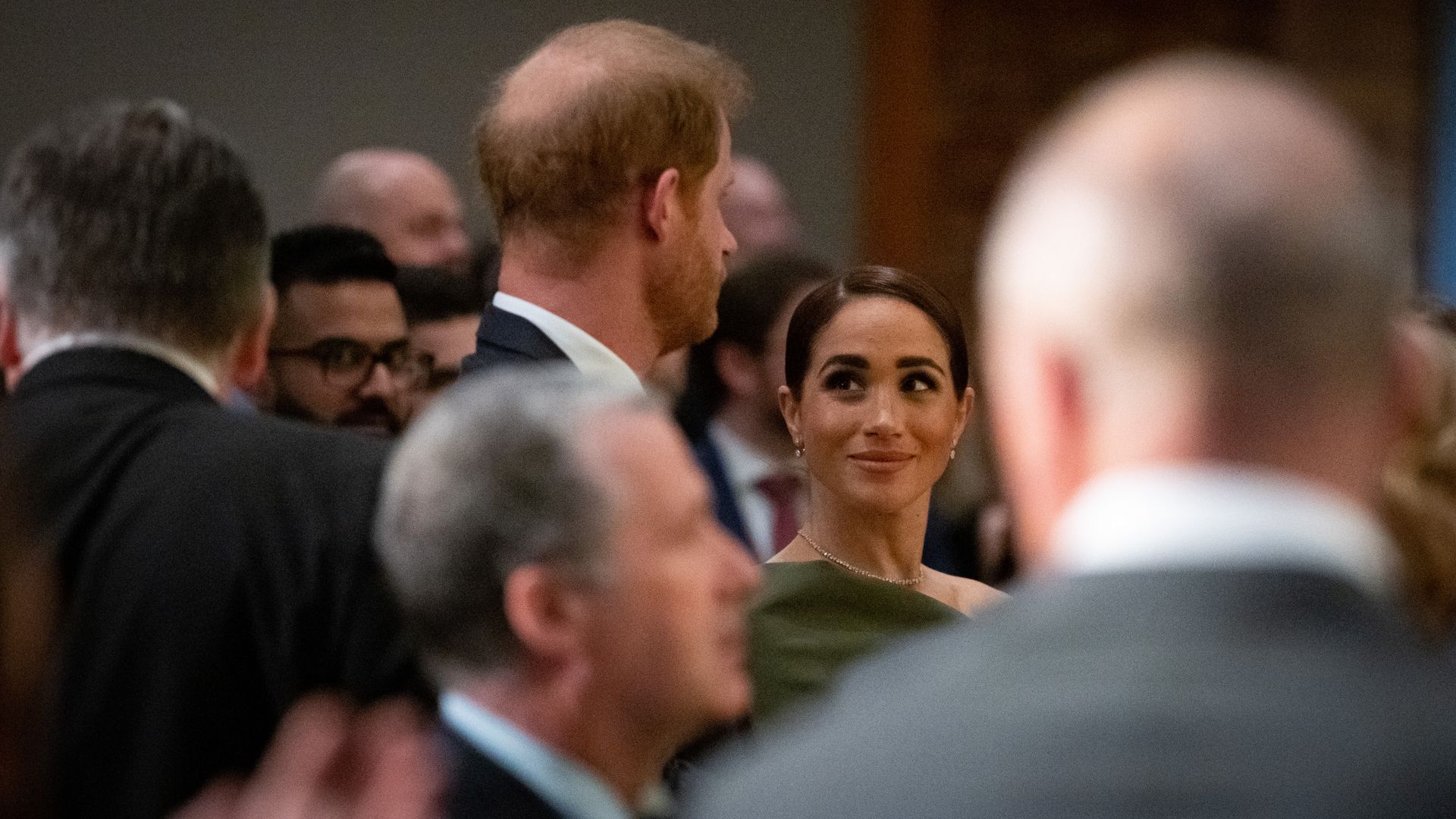 Meghan, the Duchess of Sussex, smiles at Prince Harry, the Duke of Sussex during the "One Year to Go" Invictus Games dinner 