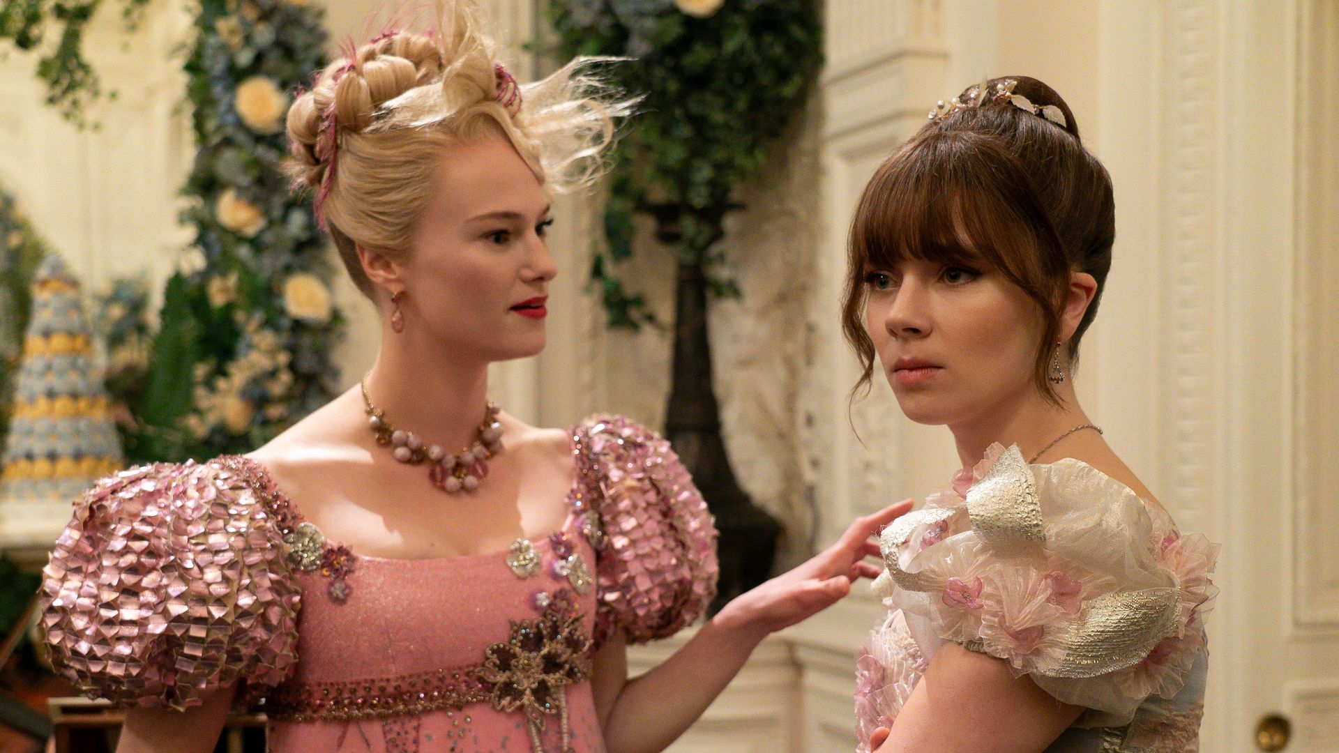 blonde and brunette women wearing period gowns