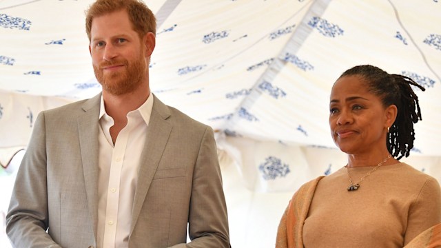 Prince Harry in a grey blazer and Doria Ragland in a cream outfit