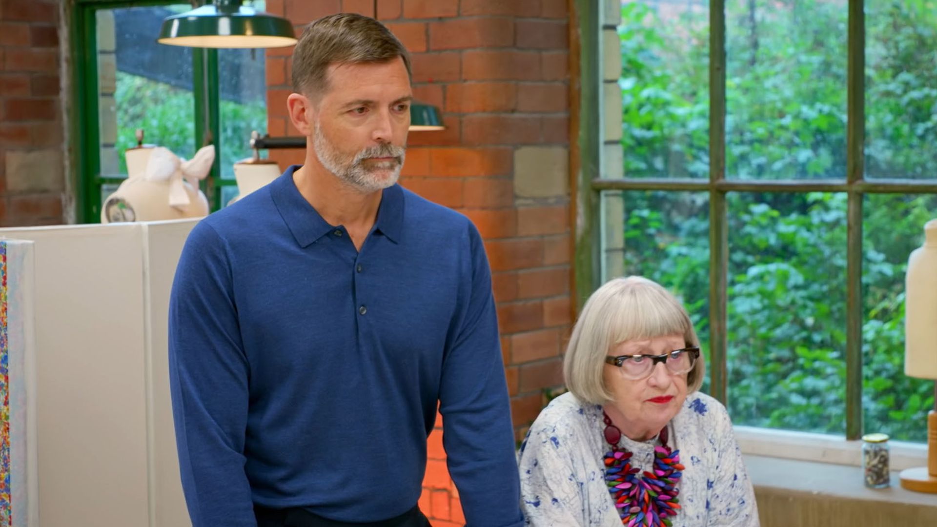 male and female presenters sitting at desk