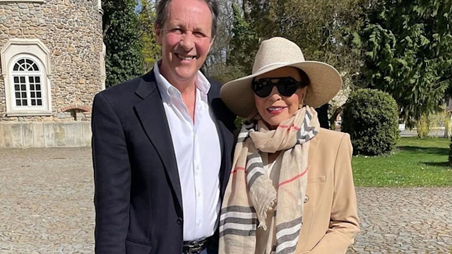 Joan Collins posing with husband Percy Gibson