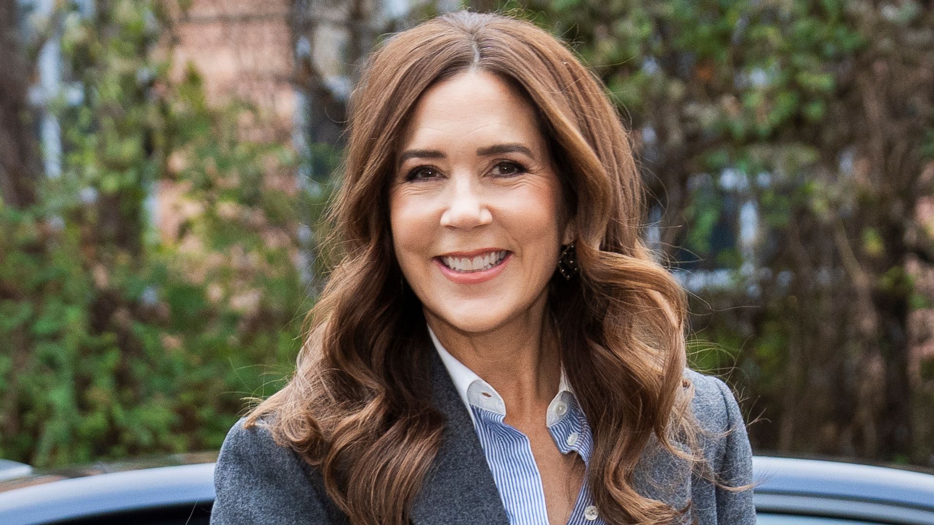 Queen Mary smiling in suit