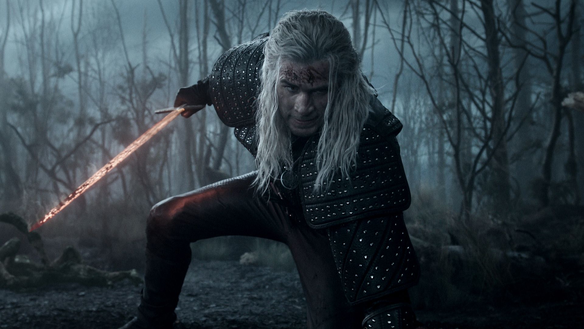 Liam Hemsworth holding a sword while in costume as Geralt of Rivia 