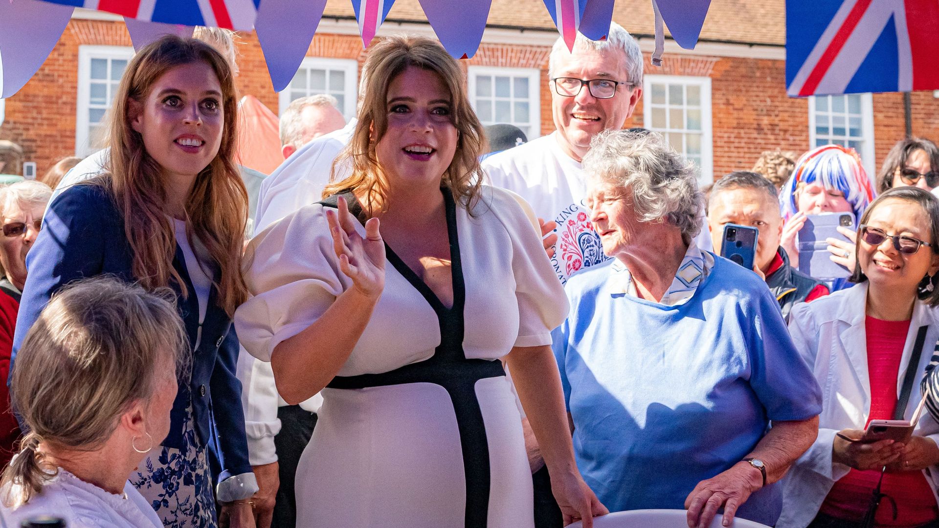 Pregnant Princess Eugenie waves at coronation street party