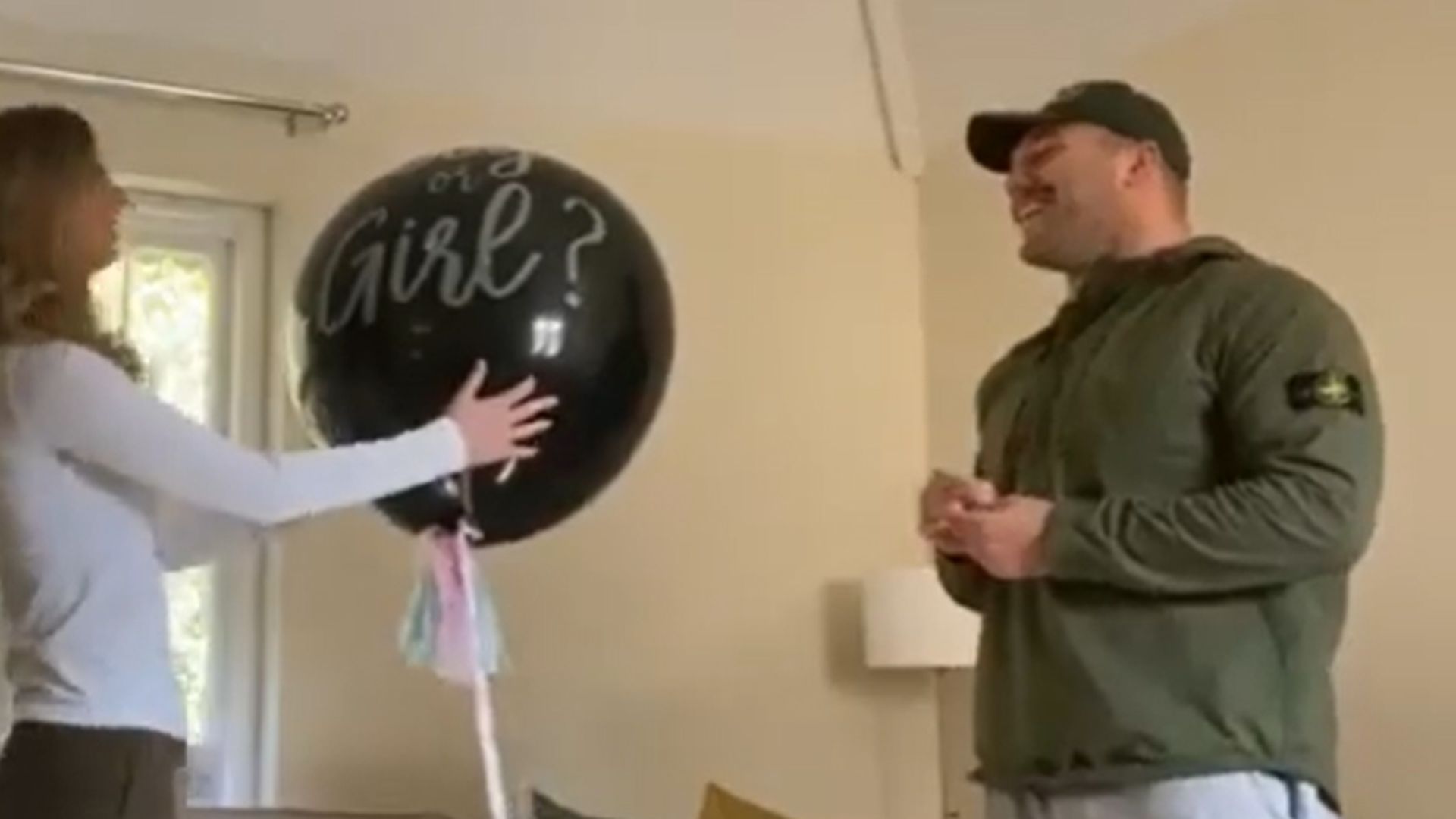 Ellis Genge and partner Meg with a gender reveal balloon