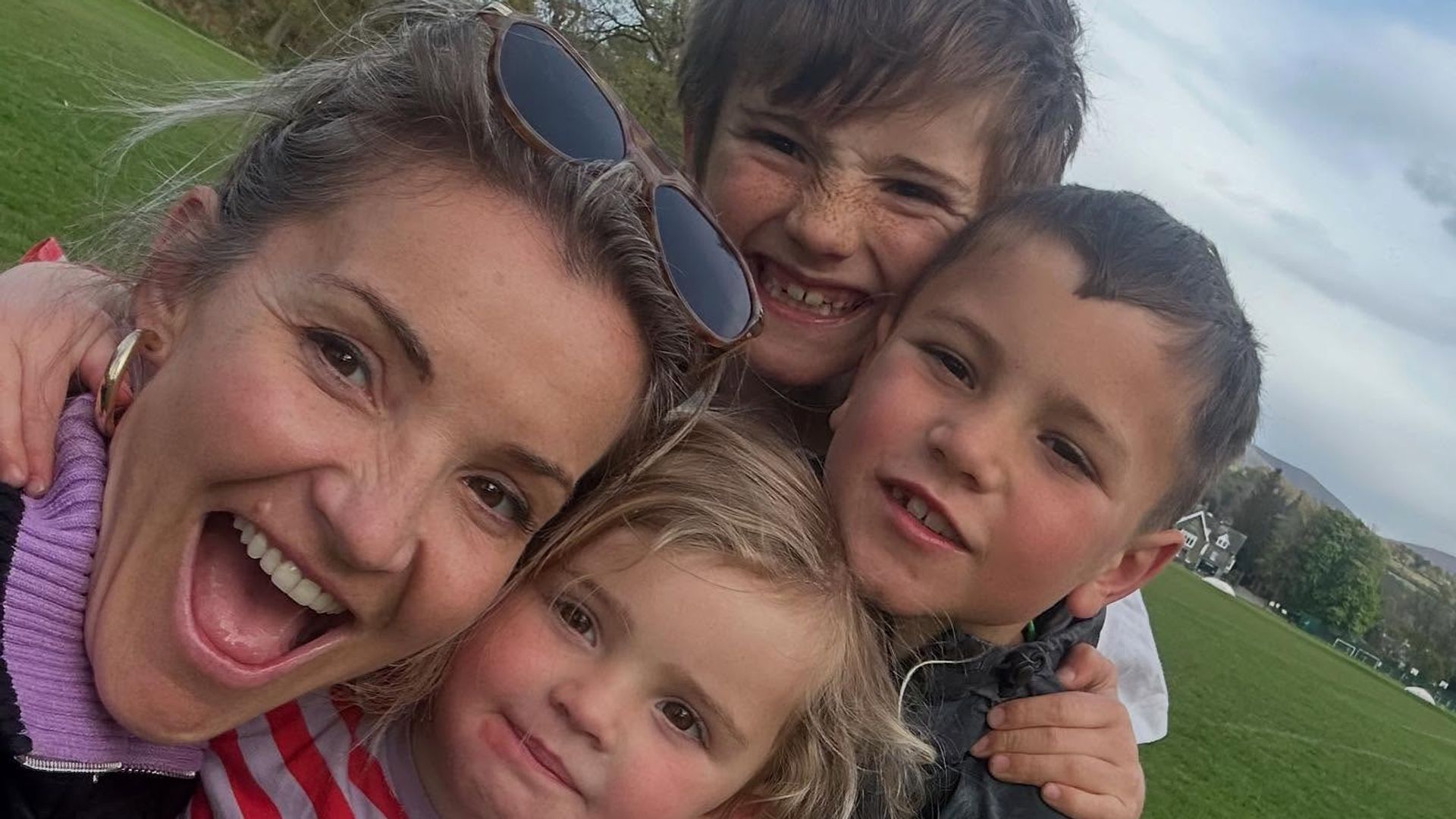 Helen selfie outside with two sons and daughter