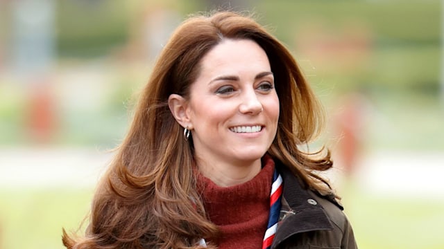 Kate Middleton wearing jumper, coat and scouts scarf