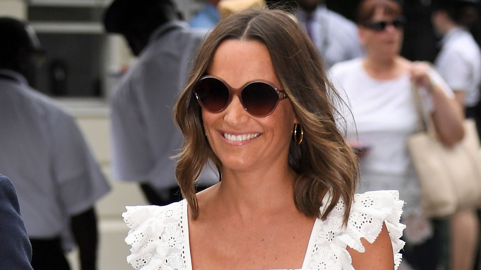 Pippa MIddleton wears a white dress and sunglasses at Wimbledon